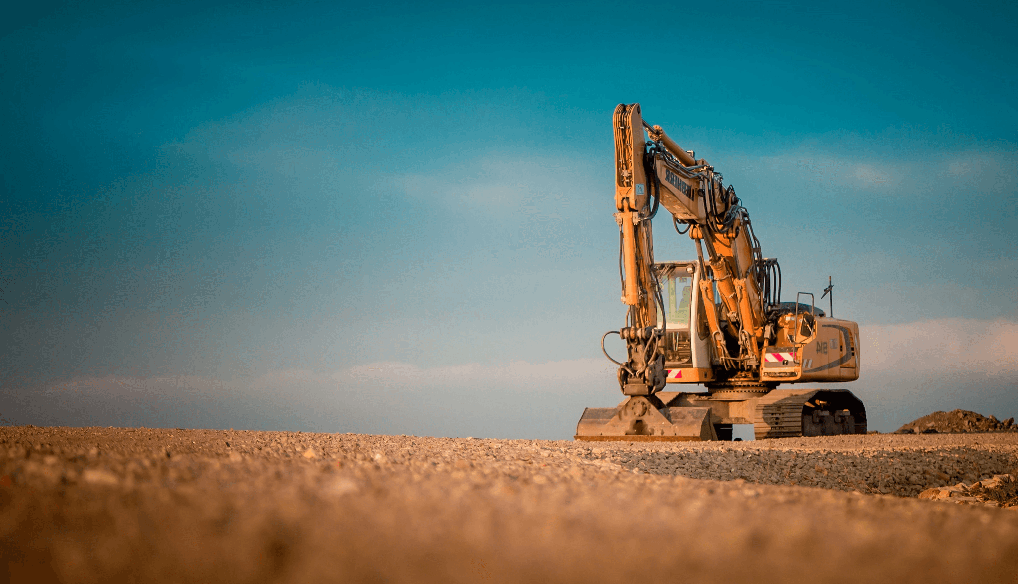 yellow and black excavator on brown sand during daytime