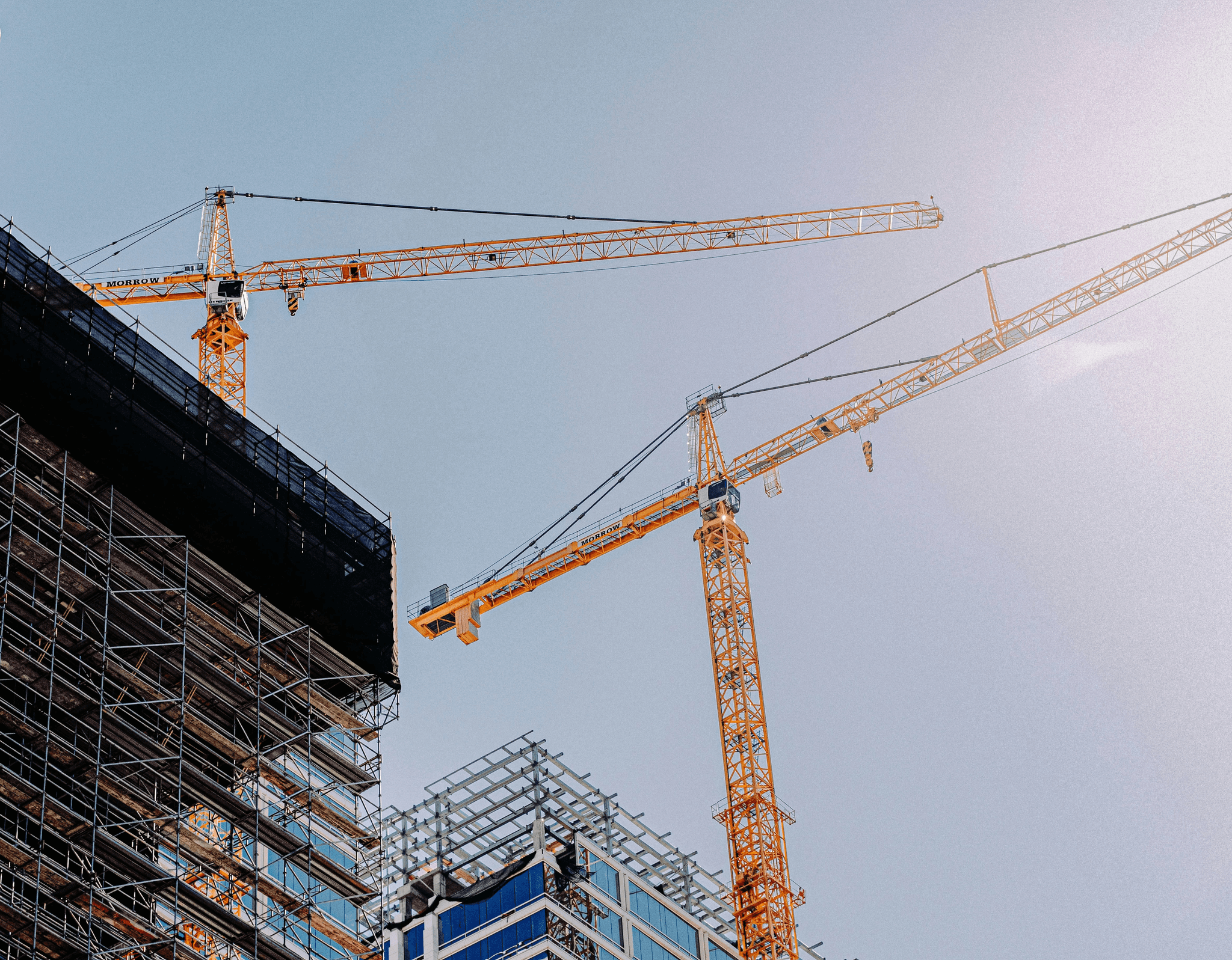 man wearing red hard hat hanged on brown rebar bar